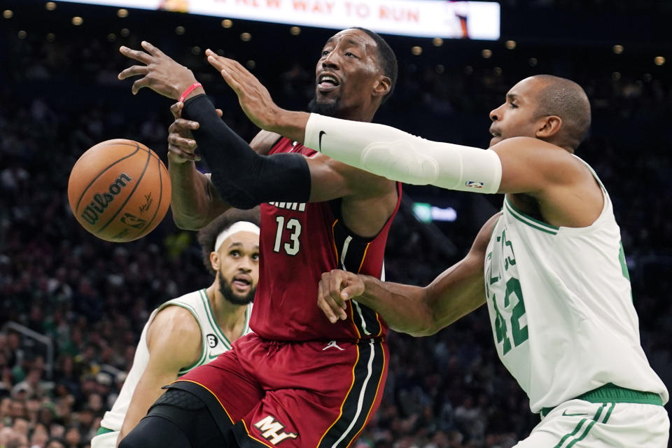 Boston Celtics center Al Horford (42) knocks the ball from Miami Heat center Bam Adebayo (13) during the second half of an NBA basketball game Wednesday, Nov. 30, 2022, in Boston. (AP Photo/Charles Krupa)