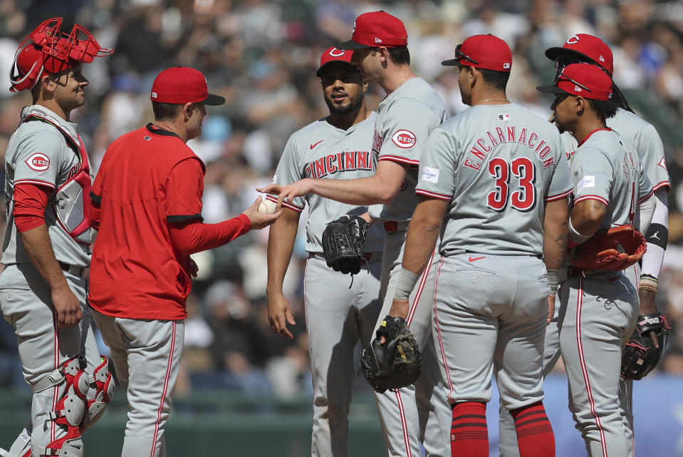 Cincinnati Reds' Nick Lodolo hands the ball manager David Bell as he is taken out in the sixth inning of a baseball game against the Chicago White Sox, Saturday, April 13, 2024, in Chicago. (AP Photo/Melissa Tamez)