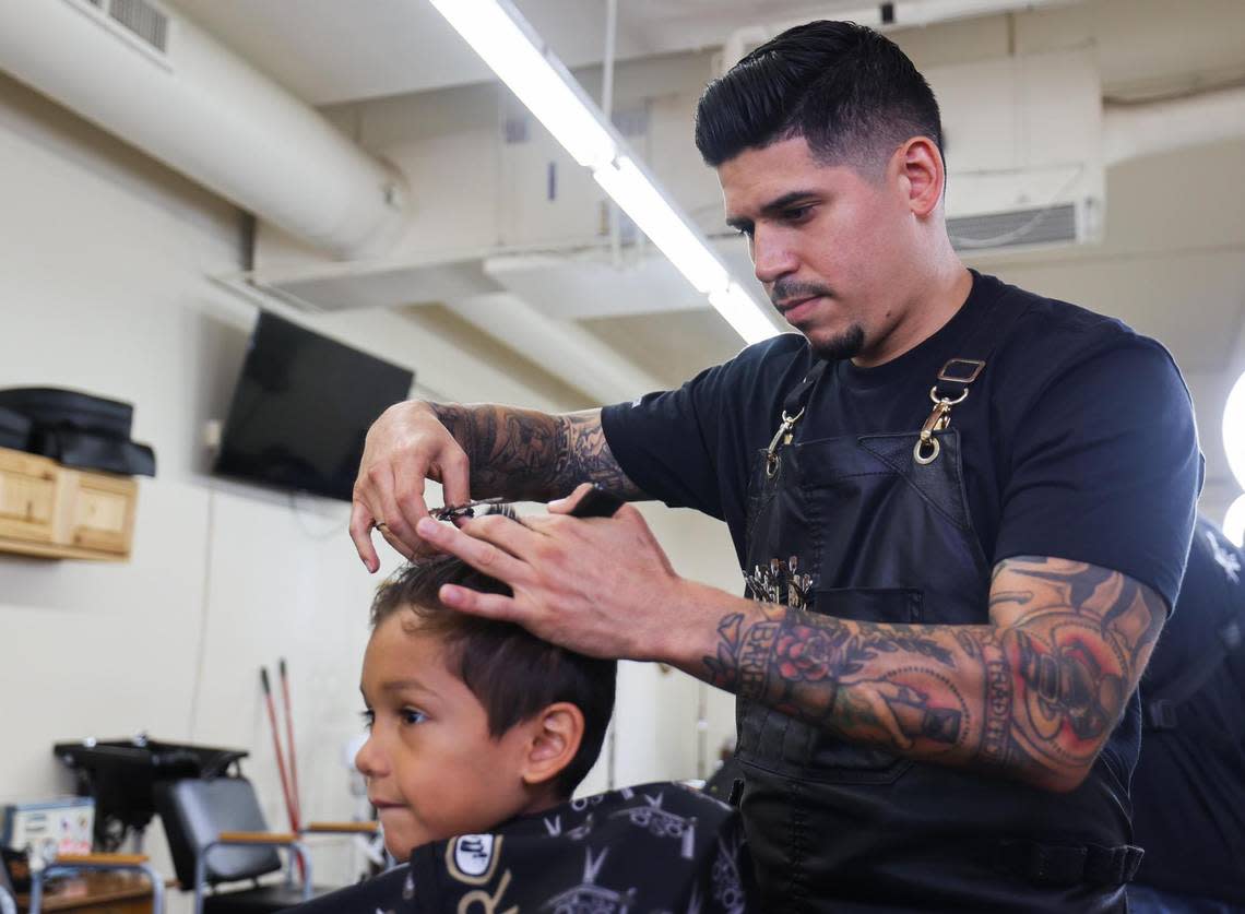 Carlos Rubio, owner, cuts Rowen Cervantes’ hair Thursday, Aug. 11, 2022, at Loso’s Barber Shop in Fort Worth.