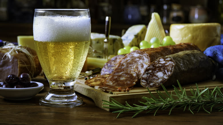 Beer and a cheese plate with meat