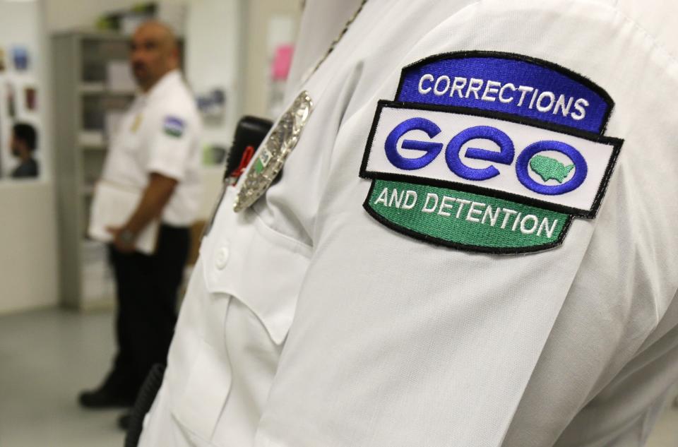 In 2017, an employee of the GEO Group wears a company patch on his uniform as he works at the Northwest Detention Center in Tacoma, Wash., during a media tour. (Photo: Ted S. Warren/AP)