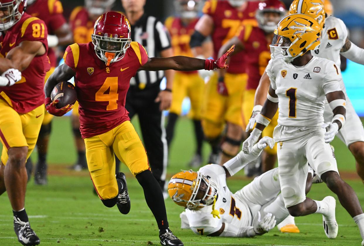 Oct 1, 2022; Los Angeles, California, USA;  USC Trojans wide receiver Mario Williams (4) runs past Arizona State Sun Devils defensive back Timarcus Davis (7) in the first half at United Airlines Field at the Los Angeles Memorial Coliseum.