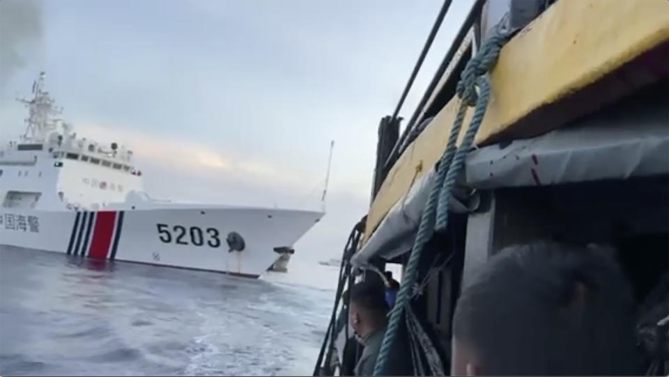 In this image from a video released by the Armed Forces of the Philippines, Filipino sailors look after a Chinese coast guard ship with bow number 5203 bumps their supply boat as they approach Second Thomas Shoal, locally called Ayungin Shoal, at the disputed South China Sea on Sunday Oct. 22, 2023. (Armed Forces of the Philippines via AP)