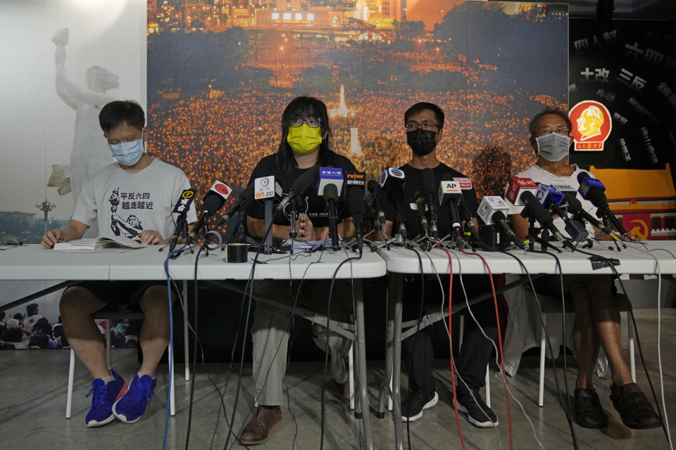 Chow Han Tung, vice chairwoman of the Hong Kong Alliance in Support of Patriotic Democratic Movements of China, second left, and other group members attend a news conference in Hong Kong, Sunday, Sept. 5, 2021. The group behind the annual Tiananmen Square memorial vigil in Hong Kong said Sunday it will not cooperate with police conducting a national security investigation into the group's activities, calling it an abuse of power. (AP Photo/Kin Cheung)