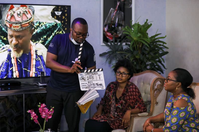 Film director Samuel Idiagbonya marks the slate during the production of Meadow series, following the relaxation of lockdown, amid the coronavirus disease (COVID-19) outbreak in Abuja