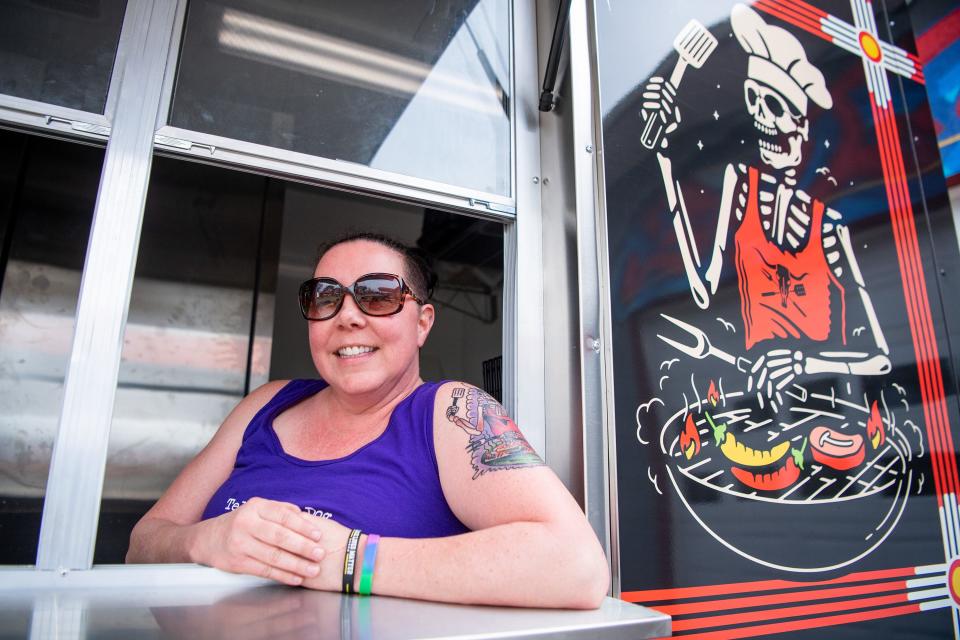 Dia De Foods co-owner Erica Collins shows off the new Dia De food truck, which remains parked at SouthSide Garage in a partnership with the Sevier Avenue business. Customers can enjoy Dia De's popular items, like the Baja Burrito, while sipping on a drink for the SouthSide bar.