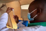 Healthcare professional prepares a dose of AstraZeneca (COVID-19) vaccine, in Narok