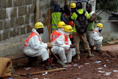 Rescue workers rest in the mountain town of Regent, Sierra Leone August 16, 2017. REUTERS/Afolabi Sotunde