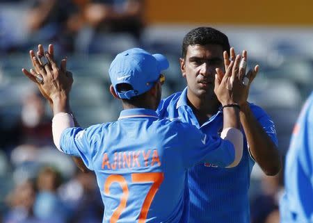 Ravichandran Ashwin (R) celebrates with team mate Ajinkya Rahane after bowling out United Arab Emirates' Mohammed Naveed during their Cricket World Cup match in Perth, February 28, 2015. REUTERS/David Gray