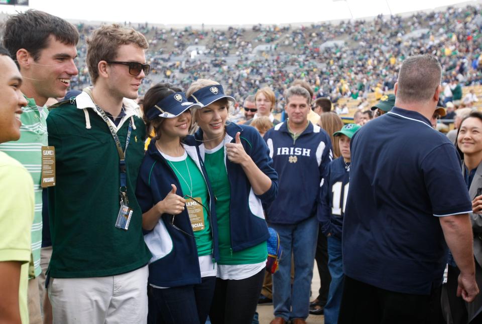 Music superstar Taylor Swift gives a thumbs-up gesture while taking a photo with fans during the Notre Dame football season opener in South Bend, Ind. on Sept. 4, 2010. Swift's brother is a 2011 graduate of Notre Dame.