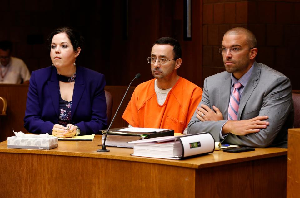 Larry Nassar (C) in court with defense attorneys Shannon Smith (L) and Matt Newberg (R) where Judge Donald Allen Jr. bound him over on June 23, 2017 in Mason, Michigan to stand trial on 12 counts of first-degree criminal sexual conduct. (Photo: JEFF KOWALSKY via Getty Images)