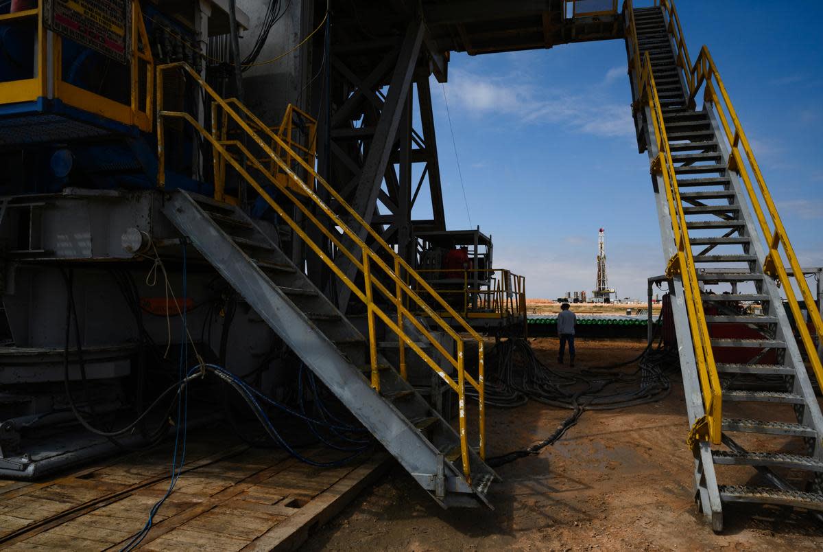 A Diamondback Energy engineer walks around the base of a drilling rig Friday, Sept. 15, 2023 in Martin County.