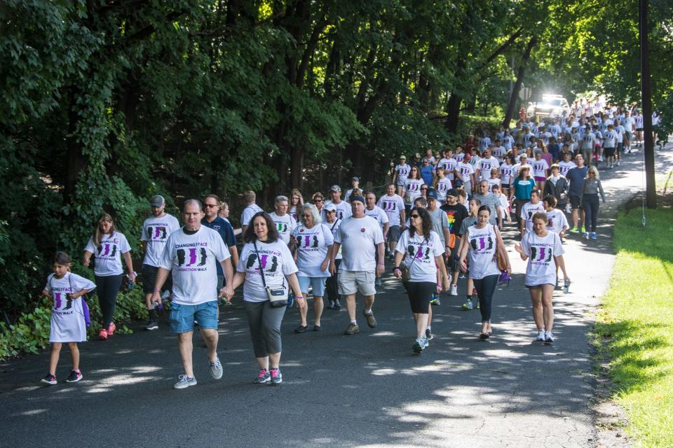 The crowd walks down the first hill at the Changing Face of Addiction Walk in Franklin, August 4, 2018.