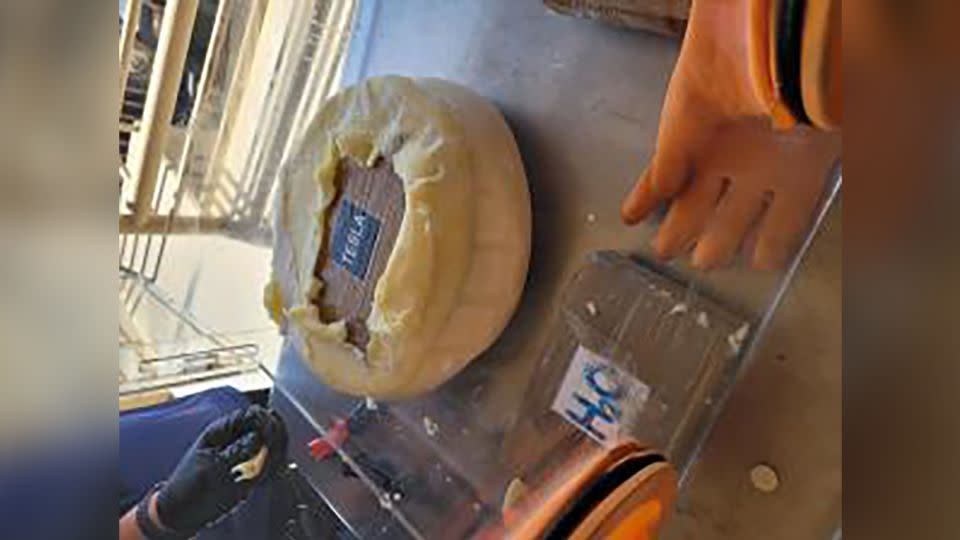 U.S. Customs and Border Protection officers seized wheels of cheese filled with cocaine at the Texas border. - U.S. Customs and Border Protection