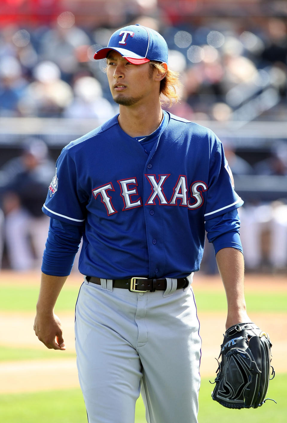 PEORIA, AZ - MARCH 07: Starting pitcher Yu Darvish #11 of the Texas Rangers walks to the dugout during the spring training game against the San Diego Padres at Peoria Stadium on March 7, 2012 in Peoria, Arizona. (Photo by Christian Petersen/Getty Images)