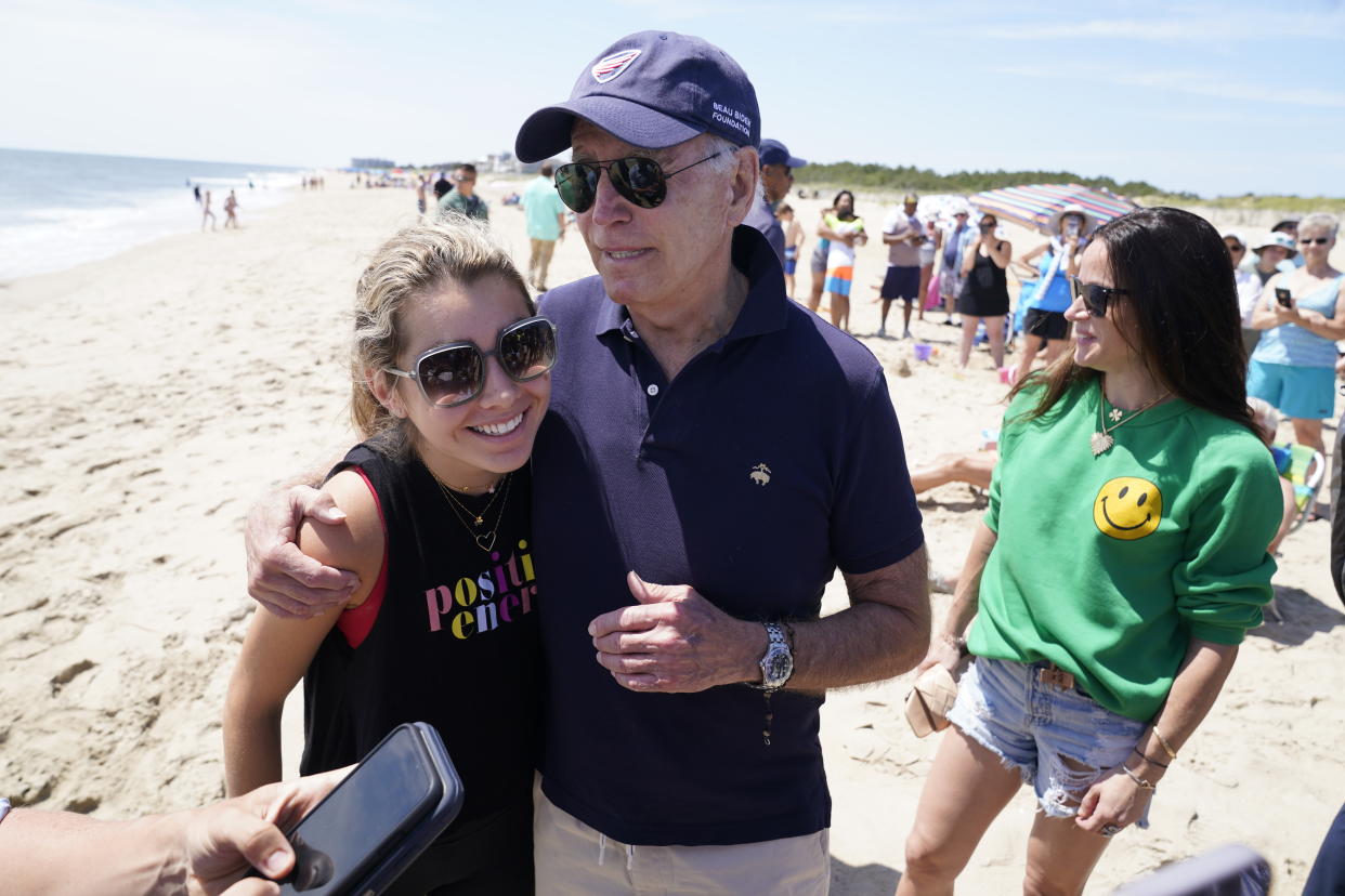 President Joe Biden talks to the media after walking on the beach with his granddaughter Natalie Biden, left, and his daughter Ashley Biden, right, Monday, June 20, 2022 at Rehoboth Beach, Del. (AP Photo/Manuel Balce Ceneta)