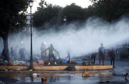 Italian Police use a water cannon as they clash with refugee squatters who had occupied a small square in central Rome, Italy August 24, 2017. REUTERS/Yara Nardi