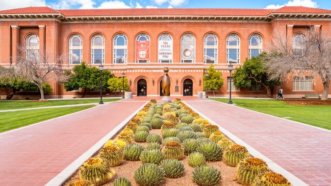 Students walk in front of the Arizona State Museum on the University of Arizona Campus in Tucson Arizona USA.