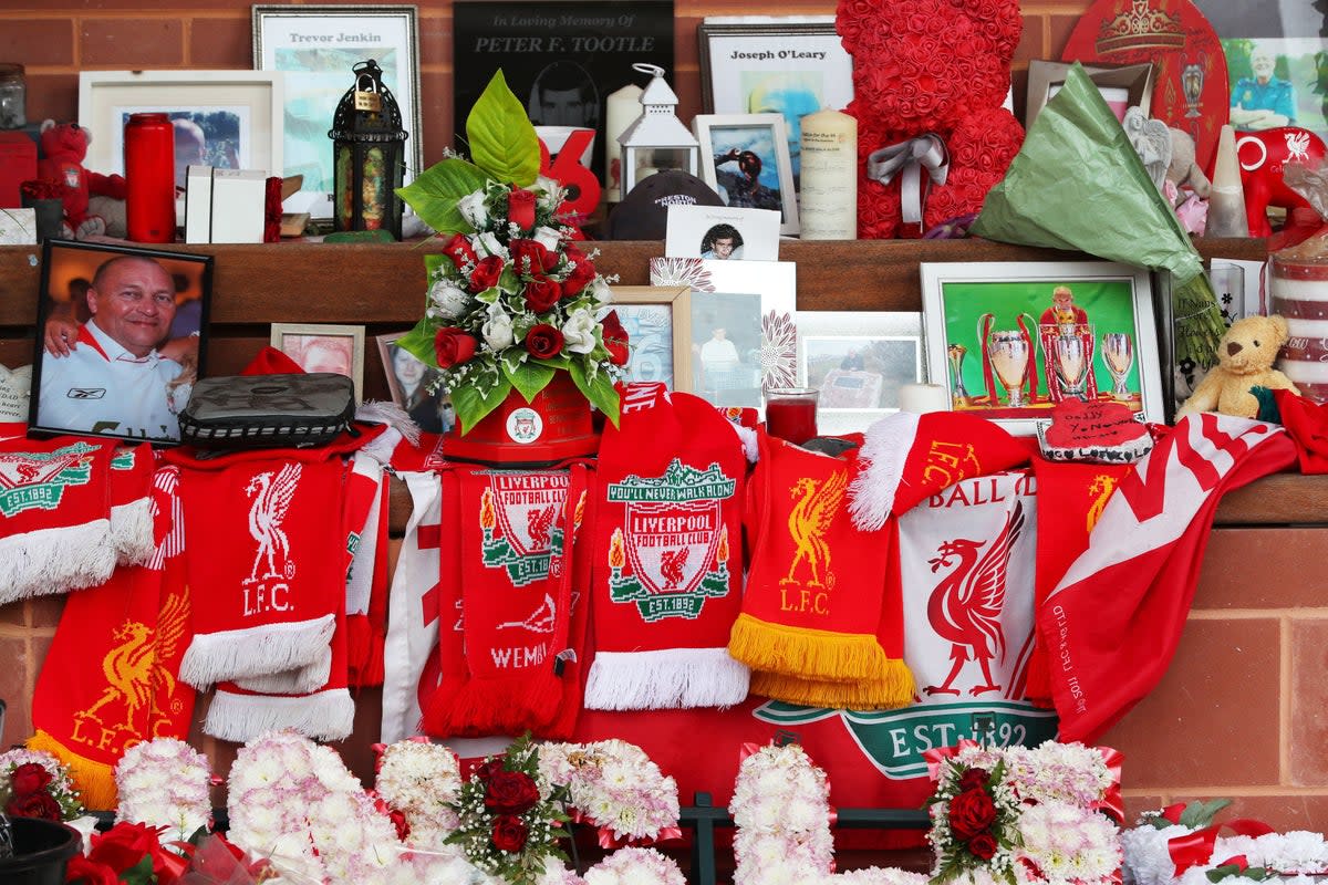 Flowers and tributes left at the Hillsborough Memorial outside Anfield stadium, Liverpool, following the collapse of the Hillsborough trial in 2021.  (PA)