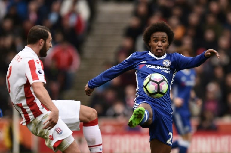 Chelsea's midfielder Willian (R) vies with Stoke City's defender Erik Pieters during the English Premier League football match March 18, 2017