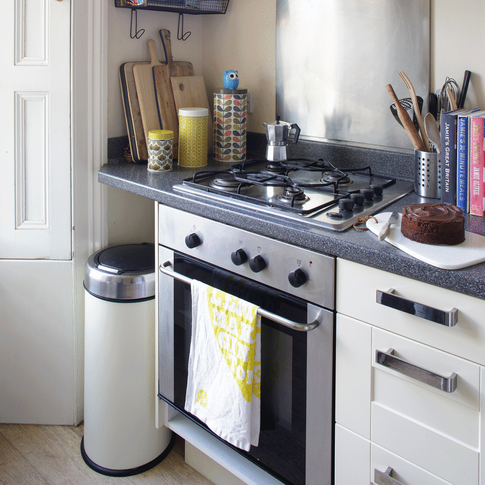 Kitchen with white drawers and white bin