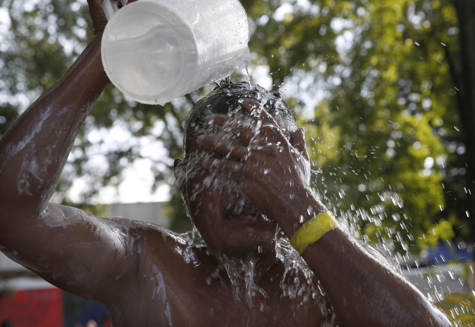 Migrant men shower in a shelter being used by a U.S.-bound caravan of Central American migrants in Irapuato, Mexico, Sunday, Nov. 11, 2018. Local Mexican officials were once again Sunday helping thousands of Central American migrants find rides on the next leg of their journey toward the U.S. border. (AP Photo/Marco Ugarte)