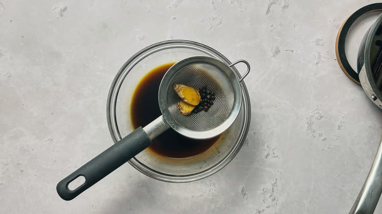 straining spices out of syrup