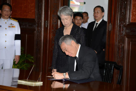 Singapore's Prime Minister Lee Hsien Loong signs a book of condolences honouring Thailand's late King Bhumibol Adulyadej, at the Grand Palace in Bangkok, Thailand, October 21, 2016. Thailand Royal Household Bureau/Handout via REUTERS