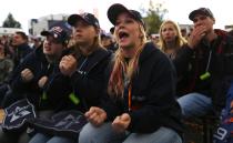 Supporters of Germany's Red Bull Formula One driver Sebastian Vettel react at the start of the Formula One Grand Prix of India in Dehli, at a public viewing session in Vettel's hometown of Heppenheim, southwestern Germany, October 27, 2013. REUTERS/Kai Pfaffenbach (GERMANY - Tags: SPORT MOTORSPORT SOCIETY)