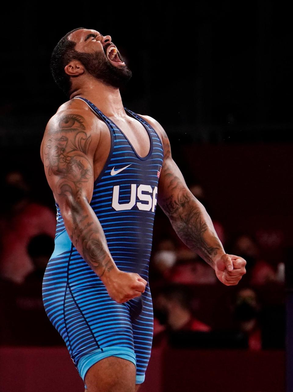Gable Steveson celebrates after defeating Geno Petriashvili in the men's freestyle 125kg final.