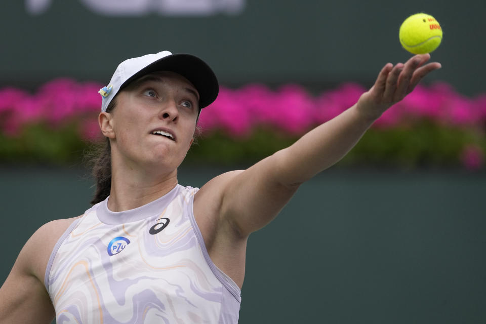 Iga Swiatek, of Poland, serves to Claire Liu at the BNP Paribas Open tennis tournament Saturday, March 11, 2023, in Indian Wells, Calif. (AP Photo/Mark J. Terrill)