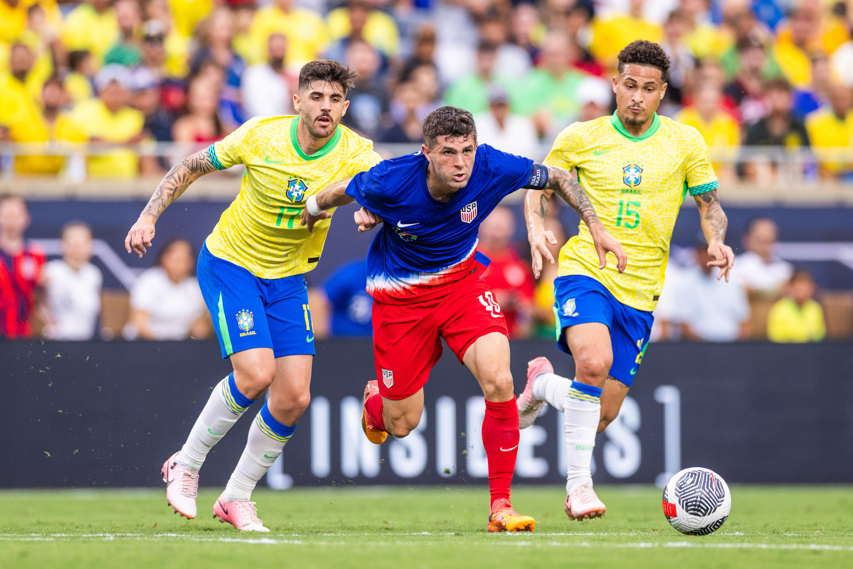 ORLANDO, FLORIDA - JUNE 12: Beraldo #17 of Brazil, Christian Pulisic #10 of the United States and Joao Gomes #15 of Brazil at Camping World Stadium on June 12, 2024 in Orlando, Florida. (Photo by Mark Thorstenson/ISI Photos/USSF/Getty Images for USSF)