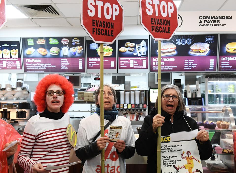 Activists protest against tax avoidance at a McDonald’s in Paris (Getty)