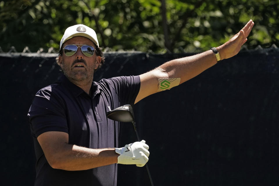 Phil Mickelson watches his tee shot on the fifth hole during a practice round ahead of the U.S. Open golf tournament, Tuesday, June 14, 2022, at The Country Club in Brookline, Mass. (AP Photo/Charlie Riedel)