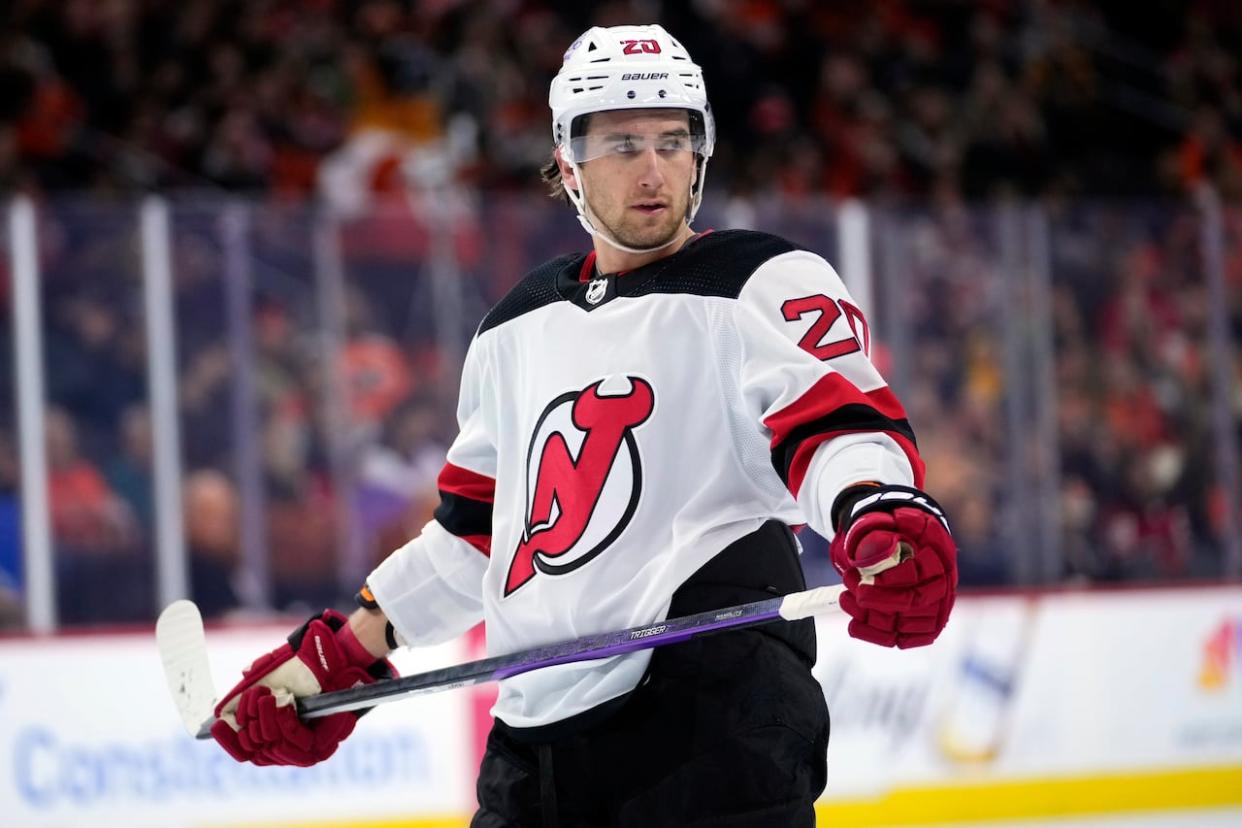 New Jersey Devils player Michael McLeod watches during a break in an NHL hockey game in Philadelphia in this Nov. 30 file photo. On Tuesday, his lawyers said McLeod has been charged in the investigation into an alleged sexual assault by members of the 2018 World Junior hockey team in London, Ont. (Matt Slocum/The Associated Press - image credit)