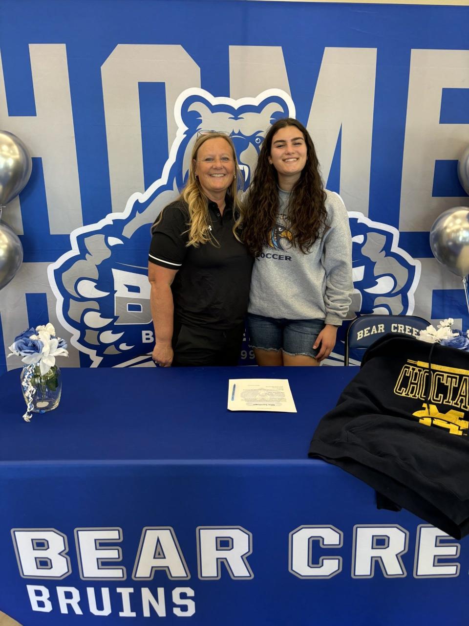 Bear Creek's Mia Santiago (left) poses for a photo next to Bear Creek's athletic director Darcy Altheide after signing her NLI to play soccer at Mississippi College this upcoming fall.