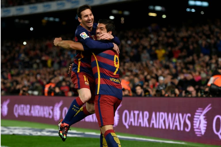 Barcelona's forward Luis Suarez (R) celebrates a goal with forward Lionel Messi during a Spanish league football match at the Camp Nou stadium in Barcelona on February 14, 2016