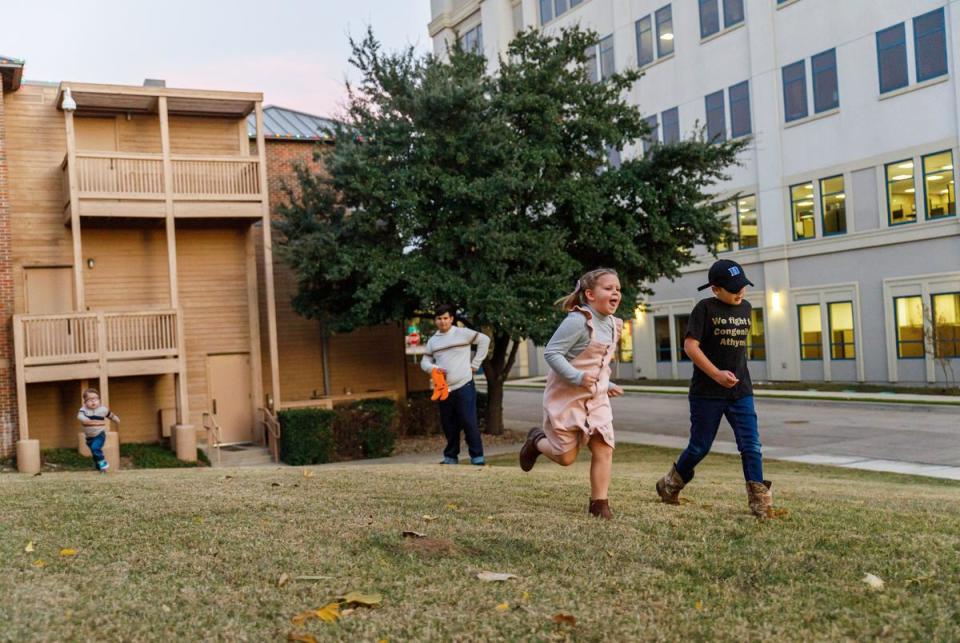 The Nolasco children, from left to right, Gabe, Johnathan, Eliana and Isaiah, race up a hill in front of the Ronald McDonald House at Cook's Children's Medical Center in Fort Worth, Texas on Dec. 2, 2023. Gabe Nolasco, 4, is currently recovering from a thymus transplant as treatment for his congenital athymia.