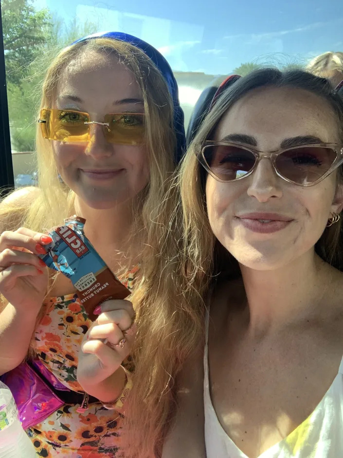 The author and her sister riding on the shuttle with a Clif bar