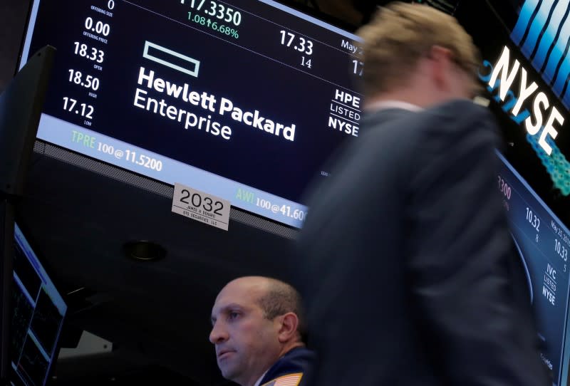 A trader passes by the post where Hewlett Packard Enterprise Co., is traded on the floor of the New York Stock Exchange (NYSE) in New York City, U.S., May 25, 2016. REUTERS/Brendan McDermid