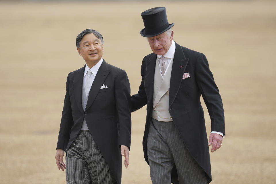 Japans Emperor Naruhito, left, and Britain's King Charles III walk back from inspecting the honour guard on Horse Guards parade during the ceremonial welcome for start of the State Visit to Britain by the Emperor and Empress in London, Tuesday, June 25, 2024. (AP Photo/Kin Cheung, Pool)