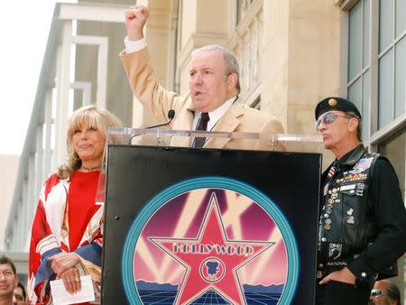 Frank Sinatra Jr. holds his fist in the air as he talks of a salute that is often given to his sister, Nancy Sinatra (L), as veterans rights advocate Artie Muller (R) looks on during the dedication ceremony for Sinatra's star on the Hollywood Walk of Fame in Hollywood, California in this May 11, 2006, file photo. REUTERS/Lucas Jackson/Files