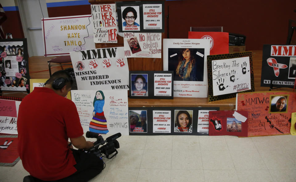 FILE - In this June 14, 2019, file photo, a photographer videos signs in memory of missing and murdered indigenous women following a march to call for justice for missing and murdered indigenous women at the Cheyenne and Arapaho Tribes of Oklahoma in Concho, Okla. A key congressional committee is holding a hearing on a slate of legislation aimed at addressing the deaths and disappearances of Native American women. The bills before the U.S. Senate Committee on Indian Affairs would require law enforcement to submit annual reports to Congress to give lawmakers a better handle on the number of cases. (AP Photo/Sue Ogrocki, File)