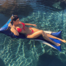 <p>She poses here on a lilo in a bright red bikini. Her body is everything!</p>