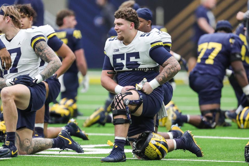 Michigan players include defensive lineman Mason Graham (55) warms up during open practice at NRG Stadium in Houston on Saturday, Jan. 6, 2024.