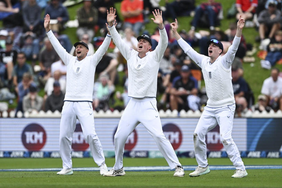 England fielders from left, Joe Root, Zak Crawley and Harry Brook appeal for a wicket on the second day of the second cricket test between England and New Zealand at the Basin Reserve in Wellington, New Zealand, Saturday, Feb. 25, 2023. (Andrew Cornaga/Photosport via AP)