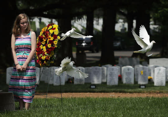 <p>Great-grandniece Madeline Brumbaugh of Springfield, Va., watches doves flying away as the birds are being released during the burial of Private First Class James Bernard Johnson on May 31, 2016, at Arlington National Cemetery in Arlington, Va. Johnson was assigned to Company K, 3rd Battalion, 8th Marines, 2nd Marine Division during WWII. He died sometime on the first day of battle against the Japanese, Nov. 20, 1943. (Alex Wong/Getty Images) </p>