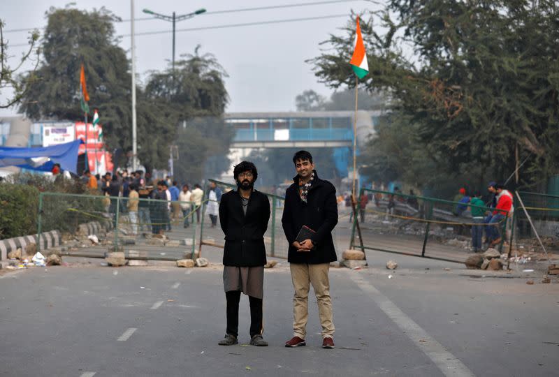 Aasif Mujtaba and Sharjeel, organisers of a sit-in protest against a new citizenship law, pose on a blockaded road in New Delhi