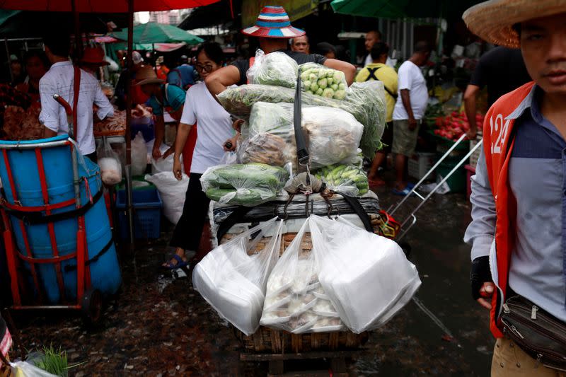 FILE PHOTO: Vegetables are carried in plastics bags at a market in Bangkok