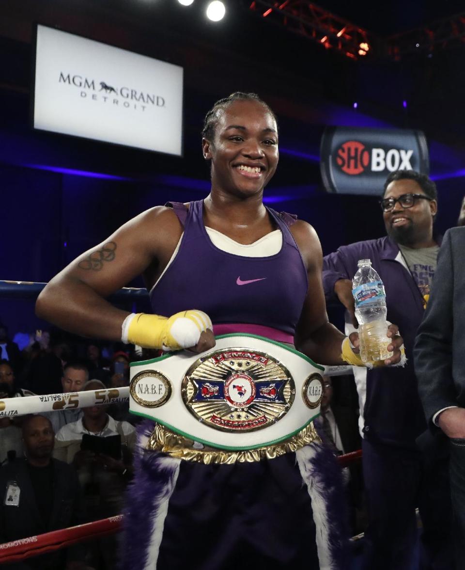 Claressa Shields poses with her North American Boxing Federation middleweight championship belt after she defeated Szilvia Szabados in the fourth round of the boxing bout, early Saturday, March 11, 2017, in Detroit. (AP Photo/Carlos Osorio)